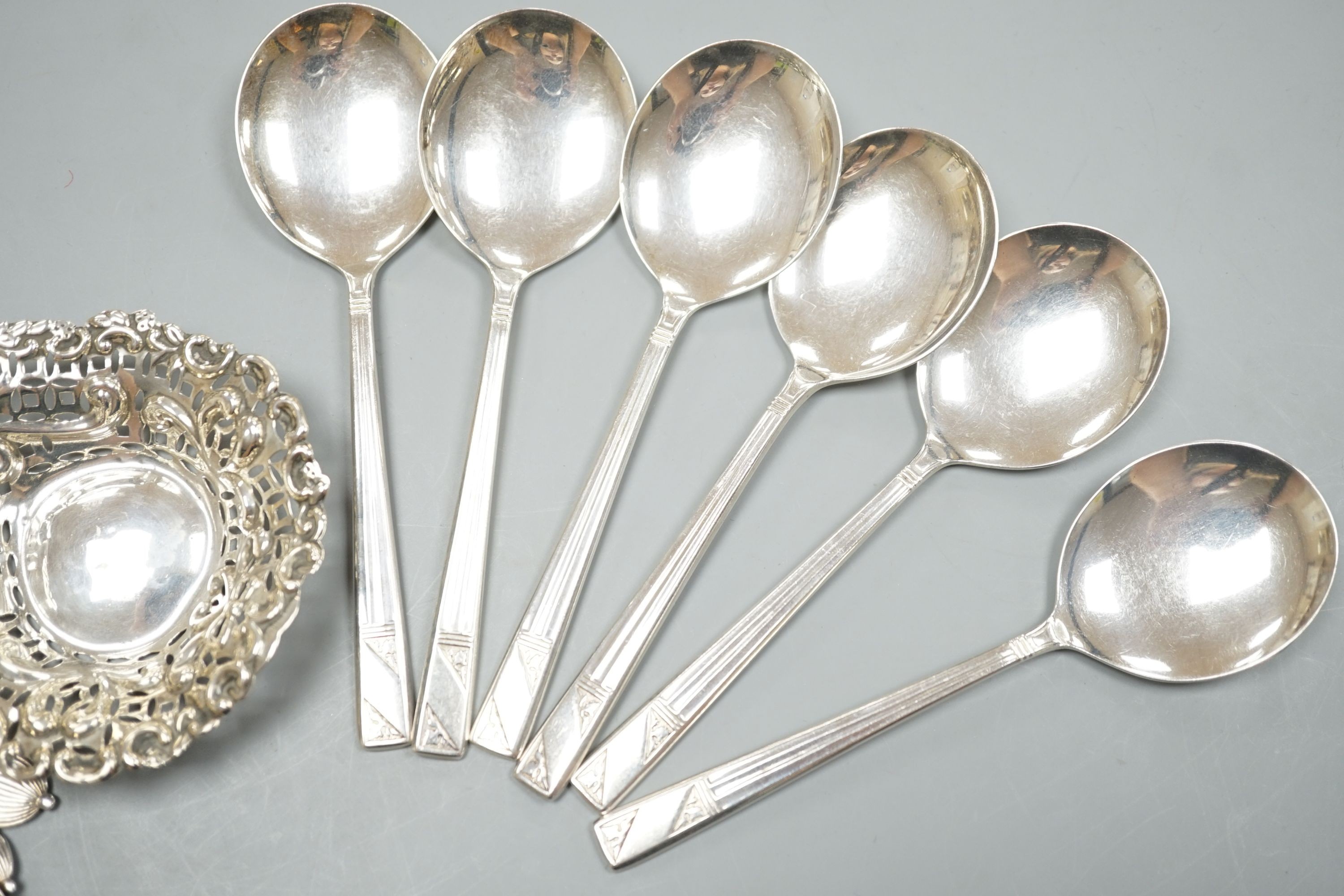 A late Victorian repousse silver bonbon dish, 91mm an assorted silver cutlery including three Victorian mother of pearl handled butter knives, a sauce ladle and two sets of six spoons including soup, weighable silver 11.